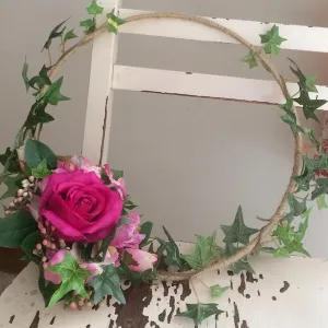 a rustic flower hoop featuring artificial silk roses & ivy